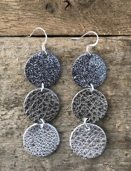 maureen-midnight-glitter-gunmetal-patent-leather-gunmetal-and-silver-leather-circle-drop-earrings