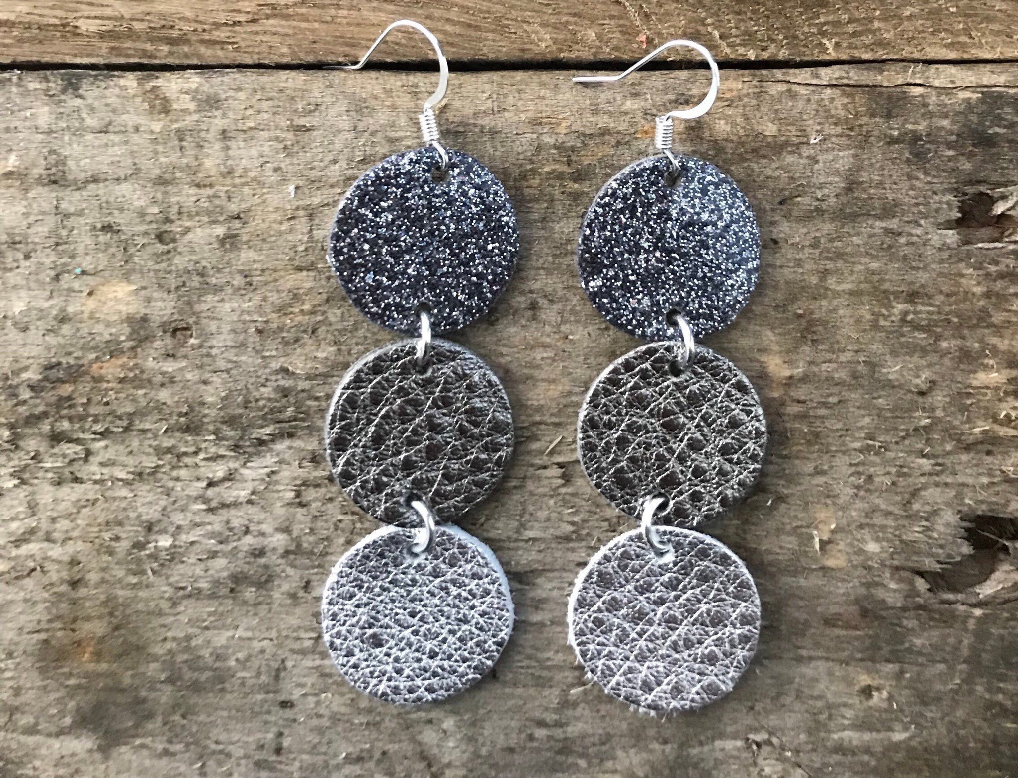 maureen-midnight-glitter-gunmetal-patent-leather-gunmetal-and-silver-leather-circle-drop-earrings